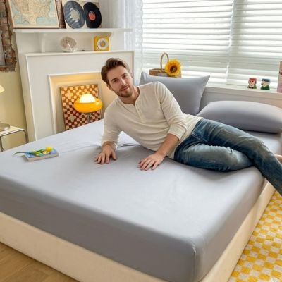 Drap housse homme semi allonge sur drap housse gris pale