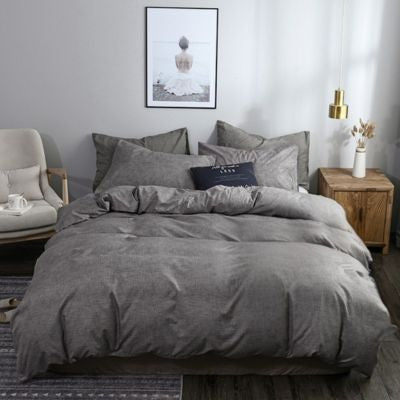 housse de couette grise sur lit chambre